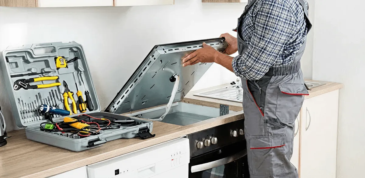 Handyman repairing a cooktop and checking wiring connections in Arlington, TX